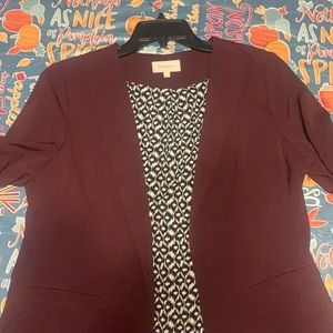 Burgundy blazer with ruched sleeves.